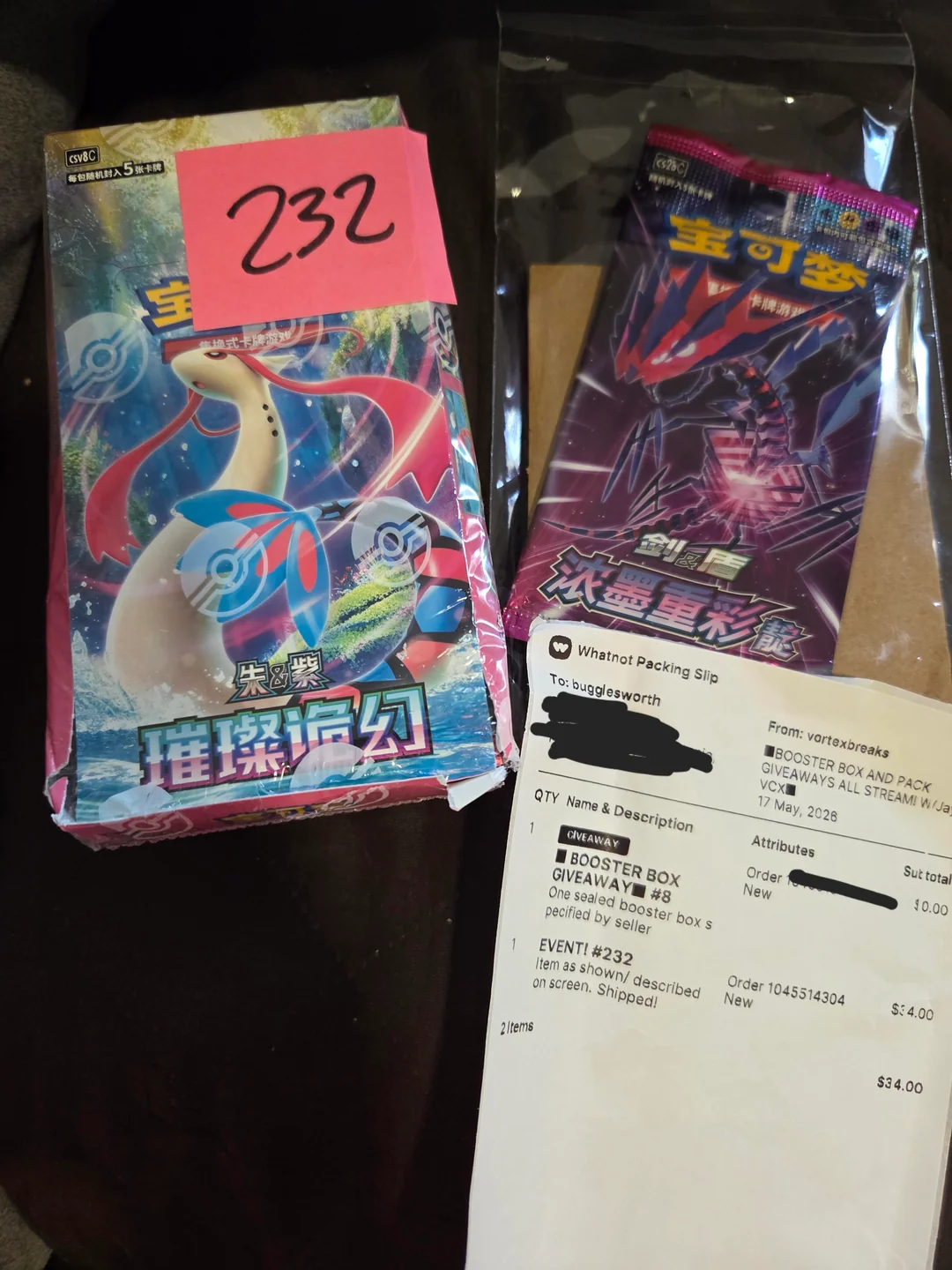 Close-up of the crushed booster box with broken seals